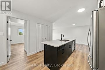 Quinte West (Murray Ward) condo for rent - A kitchen with a refrigerator on the right side.