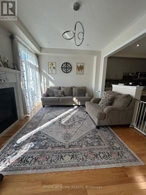 Oakville (Go Glenorchy) townhouse for rent - A living room with a rug, a couch, and a fireplace.