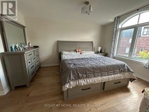 Oakville (Go Glenorchy) townhouse for rent - A bedroom with a bed, dresser, and mirror.