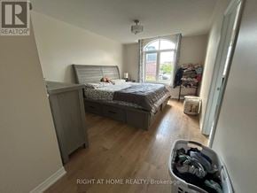 Oakville (Go Glenorchy) townhouse for rent - A bedroom with a bed, dresser, and window.