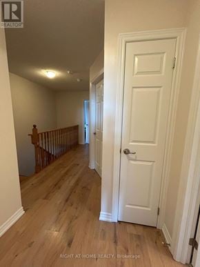 Oakville (Go Glenorchy) townhouse for rent - A hallway with a white door and wooden floors.