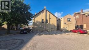 Brantford apartment for rent - A building with a sign that says REALTOR in front of it.