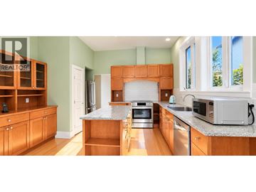 Vancouver apartment for rent - A kitchen with wooden cabinets and a granite countertop.