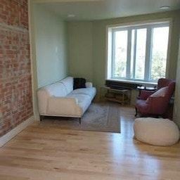 Belleville apartment for rent - A living room with a white couch and a red chair.