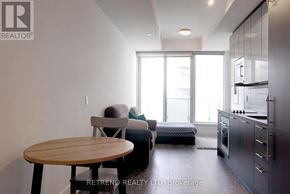 Toronto (Church-Yonge Corridor) condo for rent - A modern kitchen with a dining table and a couch.