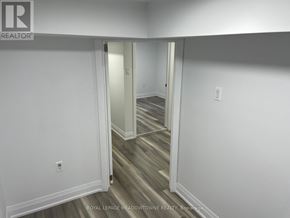 Toronto (Little Portugal) duplex for rent - A hallway with white walls and wood flooring.