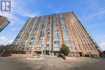 Mississauga (Cooksville) condo for rent - A tall building with many windows is the main focus of the image.