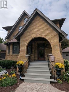 London East (East B) apartment for rent - A house with a brown brick exterior and a black metal railing on the stairs.