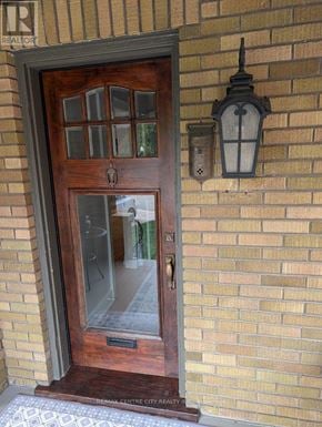 London East (East B) apartment for rent - A wooden door with a glass window and a lantern on the wall.