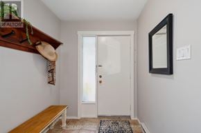 Collingwood townhouse for rent - A hallway with a bench, a door, and a mirror.