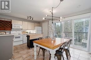 Collingwood townhouse for rent - A kitchen with a table and chairs in front of a window.