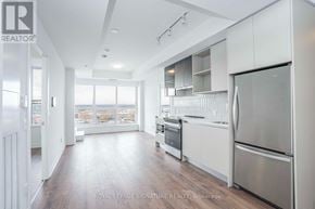 Oakville (Go Glenorchy) condo for rent - A modern kitchen with stainless steel appliances and wooden floors.