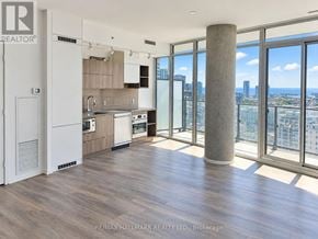 Toronto (Waterfront Communities) condo for rent - A spacious kitchen with a view of the cityscape.