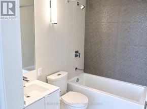 Toronto (Waterfront Communities) condo for rent - A white toilet sits next to a white sink in a bathroom.