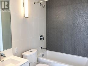 Toronto (Waterfront Communities) condo for rent - A bathroom with a white toilet, sink, and shower.