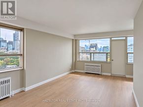 Toronto (Annex) condo for rent - A room with a view of the city through the windows.