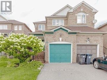 Brampton (Fletcher's Meadow) apartment for rent - A large house with a green garage door is for sale.