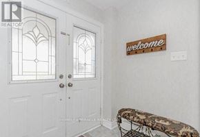 Brampton (Fletcher's Meadow) apartment for rent - A white door with a glass window and a welcome sign on the wall.