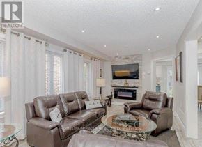 Brampton (Fletcher's Meadow) apartment for rent - A living room with a brown leather couch and a glass coffee table.