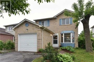 Mississauga (Meadowvale) apartment for rent - A two-story house with a garage and a small porch.