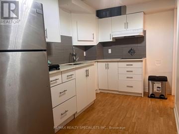 Mississauga (Meadowvale) apartment for rent - A kitchen with white cabinets and a stainless steel refrigerator.