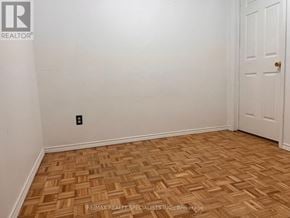 Mississauga (Meadowvale) apartment for rent - A room with a wooden floor and a white door.