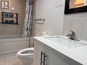 Mississauga (Meadowvale) apartment for rent - A white bathroom with a toilet, sink, and shower.