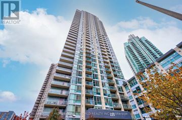 Mississauga (City Centre) condo for rent - A tall building with many windows is the focal point of the image.