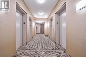 Mississauga (City Centre) condo for rent - A hallway with doors on both sides and a tiled floor.