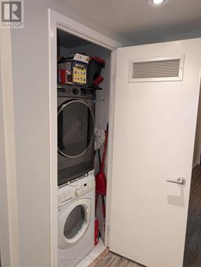 Toronto (Waterfront Communities) condo for rent - A small white laundry room with a washer and dryer in it.