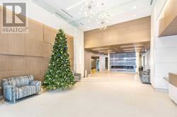 Markham (Unionville) condo for rent - A Christmas tree is in a living room with a couch and a chandelier.