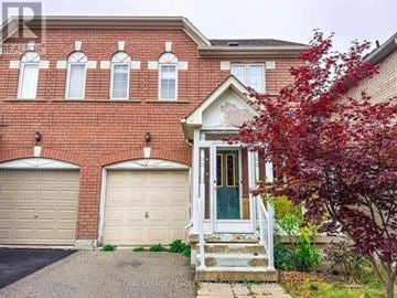 Markham (Village Green-South Unionville) apartment for rent - A red brick house with a green door and two garage doors.