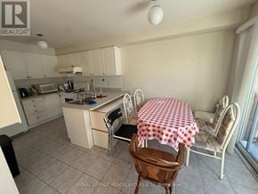 Markham (Village Green-South Unionville) apartment for rent - A kitchen with a table and chairs with a red and white checkered tablecloth.