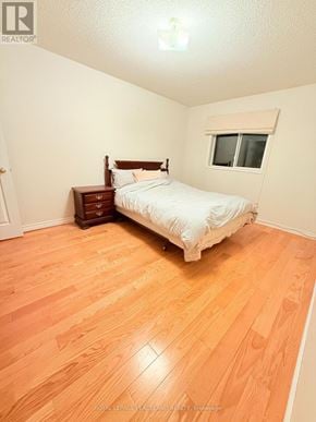 Markham (Village Green-South Unionville) apartment for rent - A bedroom with a bed, nightstand, and window.