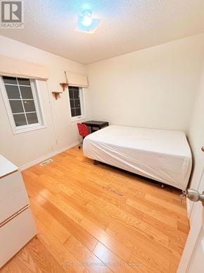 Markham (Village Green-South Unionville) apartment for rent - A bedroom with a bed, dresser, and window.
