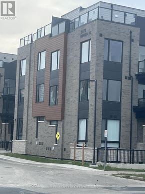 Markham (Middlefield) townhouse for rent - A building with a brown and grey facade has a sign that says "REALTOR".