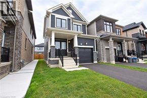 Caledonia apartment for rent - A modern two-story house with a black front door and a garage.