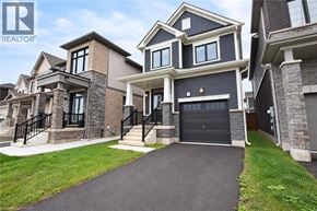 Caledonia apartment for rent - A large, modern house with a black garage door is for sale.