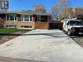Hamilton (Riverdale) apartment for rent - A white truck is parked in front of a brick house.