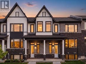 Cobourg townhouse for rent - A modern house with a large front porch and multiple windows.