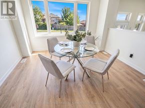 Cobourg townhouse for rent - A dining room with a glass table and chairs.