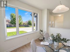 Cobourg townhouse for rent - A dining room with a glass table and chairs.