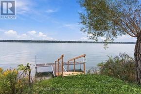 Fort Erie (Black Creek) apartment for rent - A wooden dock extends into a calm body of water.