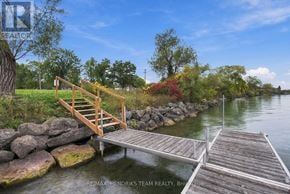 Fort Erie (Black Creek) apartment for rent - A wooden dock with a staircase leading to it extends into a body of water.