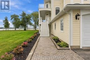Fort Erie (Black Creek) apartment for rent - A house with a white garage door and a brick walkway leading to it.
