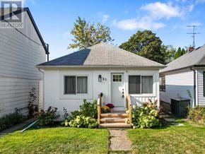 St. Catharines (Port Dalhousie) apartment for rent - A small white house with a front porch and a small garden.