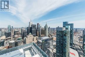 Toronto (Waterfront Communities) condo for rent - A cityscape with a clear sky and buildings of various heights.