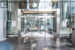 Toronto (Waterfront Communities) condo for rent - The entrance to a building with glass doors and a sign that says "No Parking".