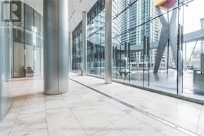 Toronto (Waterfront Communities) condo for rent - A glass and steel hallway with a marble floor.