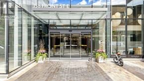 Toronto (Moss Park) condo for rent - The entrance to a building with glass doors and a sign that reads "158 FRONT ST".